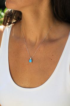 This pretty Navajo Petite Turquoise Pendant is a feminine look for a smaller person or for those who like a more modest design in jewelry. The square blue turquoise stone is bezel set and framed by smooth sleek sterling silver. A perfect piece on its own or for layering. The 18" sterling silver box chain included. Stamped "Sterling" Silver Turquoise Necklace, Turquoise And Silver Necklace, Small Stone Turquoise Necklace, Turquoise Jewelry Aesthetic, Minimalist Turquoise Necklace For Gifts, Turquoise Necklace With Square Pendant As Gift, Elegant Turquoise Necklace With Square Pendant, Elegant Turquoise Square Pendant Necklace, Real Turquoise Jewelry