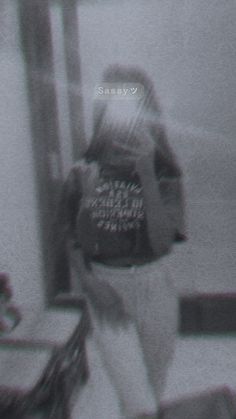 a blurry image of a man walking down the street with a backpack on his back