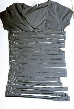 the shirt is made up of strips of plastic wrap and thread on top of each other