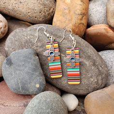 Zia Charm on a pastel serape print.  Cute earrings, a bit shorter than our zia on serape print earring.  These earrings are 1.5 inches long and are lightweight.  Super cute earrings, bright and cheerful.  The earrings would complement any outfit. Southwestern Style Dangle Earrings With Tiny Beads, Southwestern Dangle Earrings With Tiny Beads, Southwestern Style Multicolor Drop Earrings, Southwestern Tiny Beads Dangle Earrings, Multicolor Southwestern Style Drop Earrings, Southwestern Multicolor Drop Earrings, Serape Earrings, Multicolor Nickel-free Southwestern Earrings, Multicolor Southwestern Nickel-free Earrings