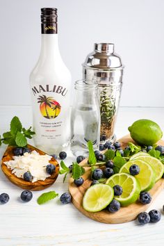 the ingredients to make an alcoholic cocktail include limes, blueberries, and coconut