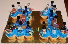 cupcakes decorated with blue frosting and bottles of alcohol