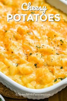 cheesy potatoes in a white casserole dish