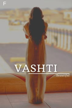 a woman standing in front of a window with the words vashiti on it