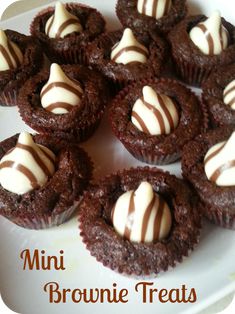 chocolate mini brownie treats with white frosting on a plate, ready to be eaten