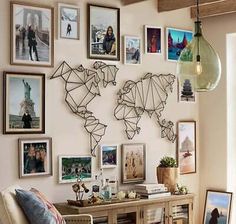 a living room filled with furniture and lots of pictures on the wall above it's desk