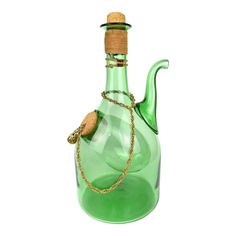 a green glass bottle with a gold chain around the neck and corked stopper