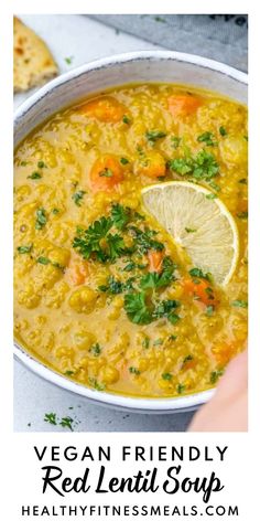 vegan friendly red lentil soup with carrots and parsley in a white bowl