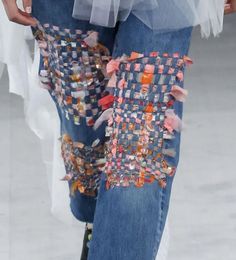 a close up view of someone's jeans with buttons on them and tulle