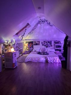 a bed room with a neatly made bed and purple lights on the ceiling above it