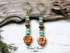 Elevate your boho chic look with these gorgeous minimalist stick earrings! These earrings feature a striking mustard colored Czech glass flower bead as the focal point, accented with vibrant turquoise picasso seed beads and antique bronze spacer beads for added elegance. Lightweight and versatile, these earrings are perfect for everyday wear or special occasions. Choose your preferred earwires to make them uniquely yours. Add a touch of bohemian charm to your ensemble with these stunning statement earrings. 𝐋𝐄𝐍𝐆𝐓𝐇: 2 1/4 with lever back earwires. Kidney wires will add about 1" 𝐖𝐈𝐃𝐓𝐇: 3/8" 𝐖𝐄𝐈𝐆𝐇𝐓: Each earring weighs1.92 grams.  A dime weighs 2.25 grams. MY OTHER SHOPS LEATHER BRACELETS, EARRINGS, AND NECKLACES: https://www.etsy.com/shop/CinfulBeadCreations PEYOTE BRACELET Bohemian Turquoise Beaded Flower Earrings, Bohemian Brown Flower Earrings, Yellow Bohemian Nickel-free Flower Earrings, Bohemian Gold Flower Earrings For Beach, Adjustable Bohemian Flower Earrings With Colorful Beads, Bohemian Adjustable Flower Earrings With Colorful Beads, Faux Jewelry, Czech Beads Jewelry, Stick Earrings