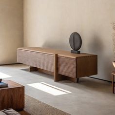 a living room filled with furniture next to a wall mounted flat screen tv on top of a wooden stand