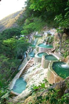 there are many small pools in the mountains with steps leading up to them that lead down into the water