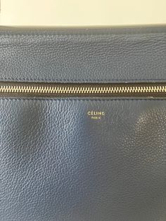 Celine Paris Blue Leather "Edge" Handbag in large size, and beautiful condition. Slight wear on outside button. Made in Italy. Fringe adorned zipper side entry, single handle, small outer pouch. Studded resting feet. A beaut! Approx. Measurements: 10 x 12.5 x 5 Paris Blues, Blue Leather, Zipper, Handbags, Paris, Blue, Leather, How To Wear