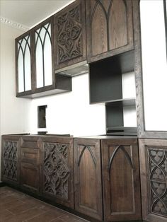 a kitchen with wooden cabinets and tile flooring in an old style home or restaurant