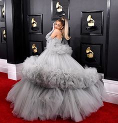 lady in grey gown standing on red carpet