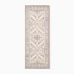 a white and grey rug with an intricate design