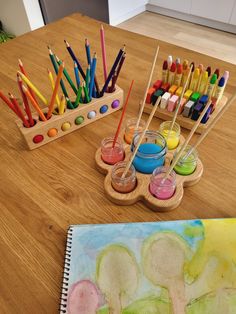 art supplies are sitting on a wooden table