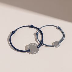 Treasure special moments together with our Personalized Father and Child Bracelet Set. Hand-engrave precious names and dates onto our delicate mini and large pastille charms. 925 Sterling SilverLarge pastille charm: 0.8x0.8Mini Pastille Charm: 0.4 x 0.4Father bracelet Size: 8-9Choose from a wide range of braid colours in durable, colourfast polyesterFully adjustable sliding knot fasteningHand-engraved in our Paris workshopSent with love in a complimentary gift boxAny slight variations in letteri Silver Bracelet With Engraving Option For Friendship, Adjustable Round Disc Bracelet For Gift, Adjustable Round Disc Bracelet Perfect As Gift, Adjustable Round Disc Bracelet As Gift, Engraved Charm Bracelet For Mother's Day, Engraved Round Charm Bracelet For Mother's Day, Minimalist Adjustable Jewelry With Engraved Text, Blue Stamped Bracelet As Gift, Adjustable Sterling Silver Jewelry With Engraved Text