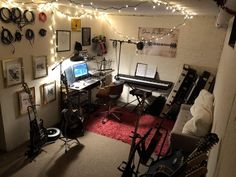 a room filled with lots of musical equipment and lights hanging from the ceiling above it