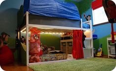 a bunk bed with red curtains on the top and bottom is in a child's bedroom