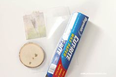 the contents of a toothbrush and its packaging on a white table with a small piece of paper