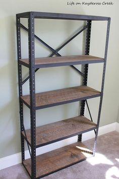 an empty shelving unit in the corner of a room with carpeted flooring