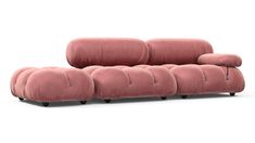 a pink couch sitting on top of a white floor