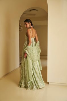 This sharara set features all-over delicate sequin embroidery on a mint green net base. The outfit is paired with a full embroidered peplum top and a matching dupatta.From Seema Gujral's Fiori - the sharara edit collection. DELIVERY TIMEPlease allow 8-12 weeks for your outfit to arrive. FABRIC DETAILSNet Professional cleaning only. Sequin Sharara, Mehndi Ceremony, Dress Code Wedding, Sequin Embroidery, Designer Dresses Casual, Sharara Set, Green Sequins, Sequins Embroidery, 12 Weeks