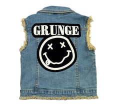 Experience the ultimate coolness with this medium denim wash vest featuring raw edge sleeves and button closure. Adorned with trendy patches and buttons, it's the must-have for all Grunge kids fans! Trendy Distressed Cotton Denim Vest, Grunge Distressed Cotton Denim Vest, Trendy Distressed Denim Vest For Streetwear, Cotton Grunge Denim Vest For Spring, Grunge Kids, Trendy Patches, Grunge Denim, Kids Fans, Foxtrot