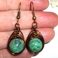 Wire Wrap Earrings Bronze Green Beaded Handmade Dangle Drop Jewlery Gift C315 This Costume Jewelry Beaded Earring Set Is Brand New Nwt And Handmade By Me - Wvluckygirl. Handcrafted With Green Acrylic Beads With A Beautiful Marbling In Black, Blue, Brown And Hints Of White. These Were Wire Wrapped With Brown Bronze Toned Tarnish Resistant Wire To Form A Basket Weave Around The Beads. The Pair Dangle And Drop From French Fishhook Ear Wires For Her Pierced Ears. From Top To Bottom They Measure 1 5/ Wire Wrap Earrings, Vine Jewelry, Peace Earrings, Earrings Bronze, Brown Pearl Earrings, Celtic Knot Earrings, Bronze Green, Costume Jewelry Sets, Fancy Dress Up