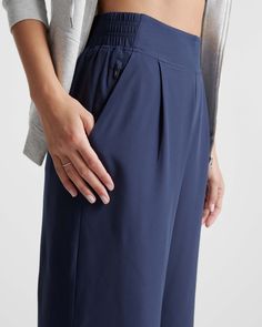 These look like classic work pants, but move like your favorite activewear. Our cropped Performance Tech Wide Leg Commuter Pants have just the right amount of stretch for days when you’re on the go, plus the sun protection and quick-dry properties of top-notch performance wear. And they look great with sneakers.  | Quince | Women's Performance Tech Wide Leg Pants in Navy, Size XS, Recycled Polyester Boyfriend Cardigan, Performance Leggings, Performance Wear, Wide Leg Pant, Work Pants, Linen Pants, Spandex Fabric, Crop Tank, Warm Weather