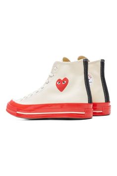 WhiteReimagining the first Converse x PLAY Comme des Garçons design, this iteration features a red midsole and foxing with a contrast pinstripe and is rendered in both black and white premium canvas stamped with the instantly recognisable heart-and-eyes logo.Upper: TextileSole: RubberPlease note these run 1/2 a size large, we recommend sizing down. Red High-top Sneakers With Rubber Sole For Streetwear, Retro Mid-top Sneakers With Red Sole, Retro Red Custom Sneakers With Rubber Sole, Retro Custom Sneakers With Red Sole And Round Toe, Red High-top Sneakers With Gum Sole For Streetwear, Red Mid-top Sneakers With Gum Sole, Red High-top Sneakers With Red Sole For Streetwear, Red High-top Sneakers For Streetwear, Red Retro Custom Sneakers With Round Toe