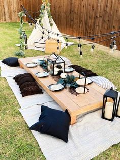 a picnic table set up with plates and candles