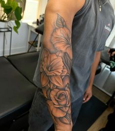 a man with a flower tattoo on his arm