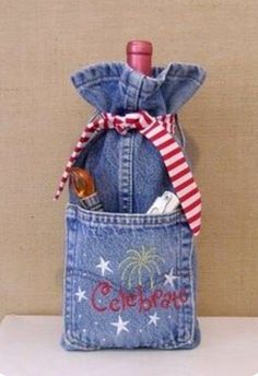 a bottle in a jean pocket with a red and white striped bow on the top