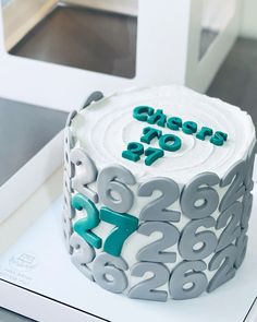 a cake with white frosting and blue decorations