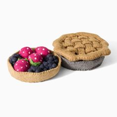 two pies with strawberries and blueberries in the middle one is made out of felt