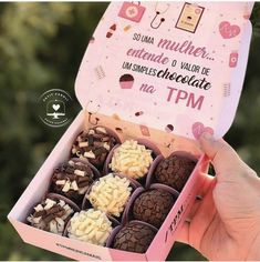 a pink box filled with lots of chocolates