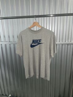 Y2K Nike tee -Size: Medium -Condition: 9/10 near perfect condition!  No major flaws  Please message for any further questions 90s Style Gray Graphic Print Top, Basic Gray Shirt For Streetwear, Branded Crew Neck Tops For Streetwear, 90s Style Short Sleeve Shirt With Logo Print, 90s Style Gray Cotton Tops, Vintage Cotton Top With Branding, 90s Style Cotton T-shirt With Crew Neck, Gray Graphic Tee With Branding, Vintage Nike Shirt