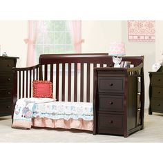 a baby's crib in a room with dressers and bedding on the floor