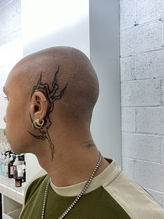 a bald man with a tattoo on his head