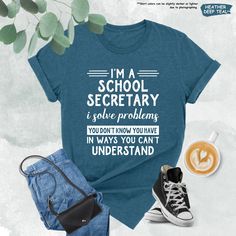 a t - shirt that says i'm a school secretary and some other items