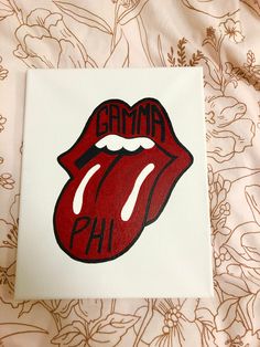 the rolling stones logo painted on top of a white piece of paper with red lips