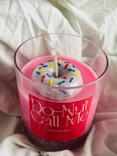 a donut candle is sitting in a glass container