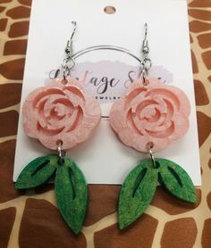 This listing is for a Pink Rose Resin earrings with a leaf dangling. Ear wire closure. Pink Rose Design Dangle Earrings, Pink Dangle Jewelry With Rose Design, Pink Rose Design Dangle Jewelry, Pink Rose Design Drop Earrings, Rose Colored Dangle Jewelry With Rose Design, Handmade Rose Dangle Earrings, Rose Color Flower Drop Earrings, Handmade Rose Drop Earrings, Rose Drop Earrings With Rose Design