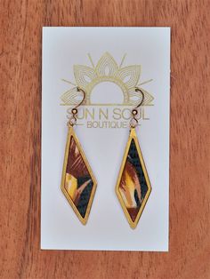 a pair of earrings sitting on top of a card