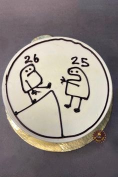 a cake with a drawing of two people on the front and one is in the middle