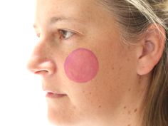 a woman with a pink spot on her face