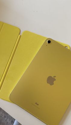 two yellow ipads sitting next to each other